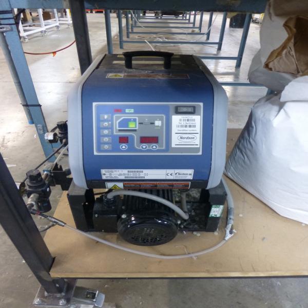 Nordson Durablue 4L hot glue machine s/n NC12K03441 with 2x Nordson AD-41 hand held dispensers and steel framed mobile work table